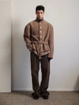 Brown corduroy belted jacket with faux shearling collar shown in a full front streetwear outfit with wide-leg trousers