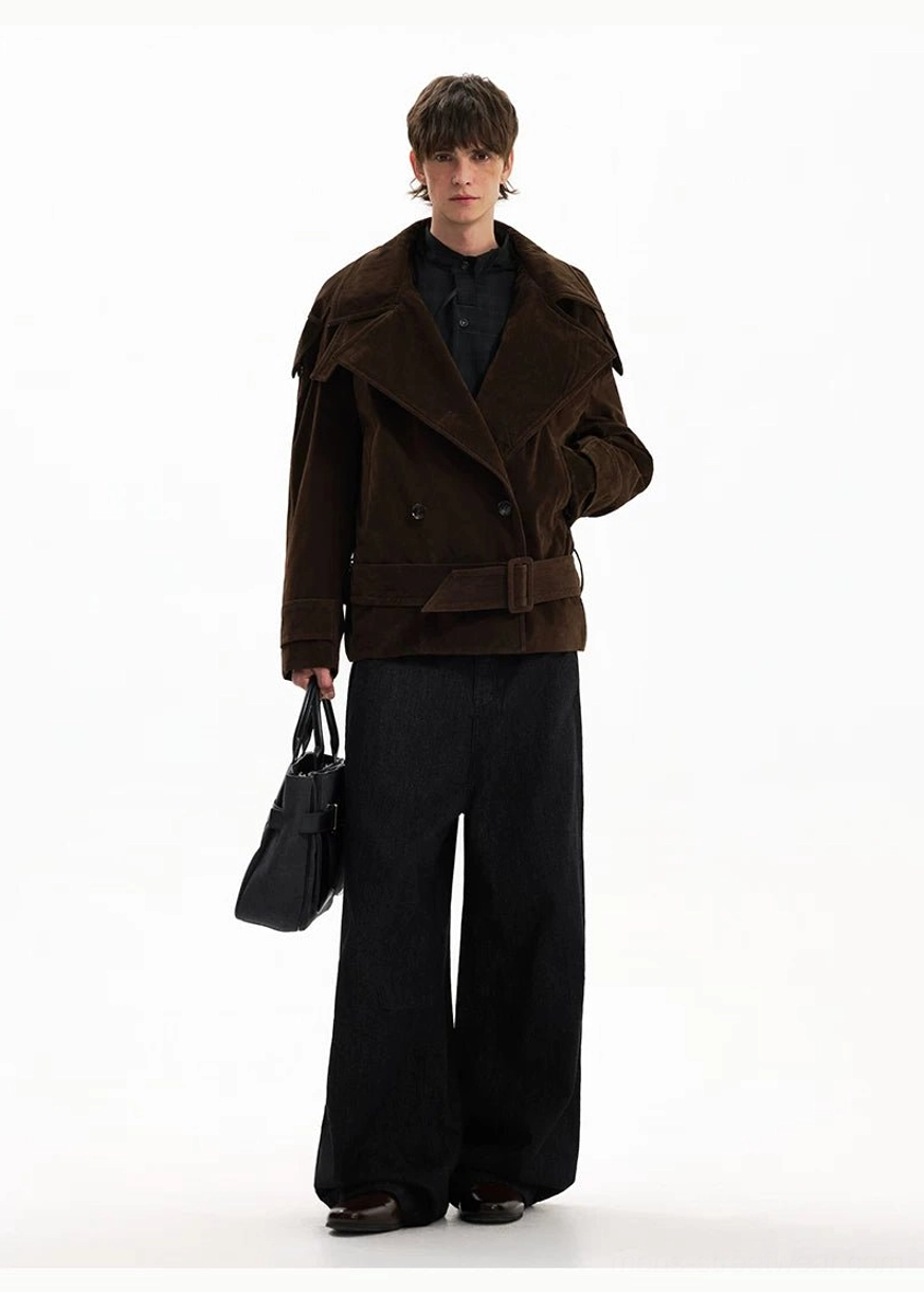 Side view of brown cropped corduroy trench coat with waist belt and black tote bag