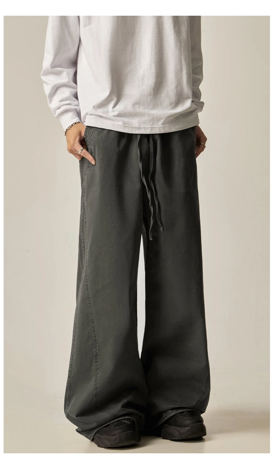 Brown drawstring wide-leg pants lifestyle detail close-up washed fabric texture cotton material quality construction