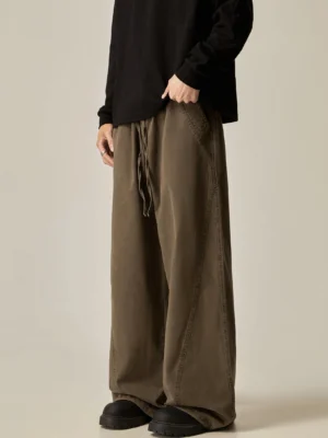 Brown loose drawstring wide-leg pants left side three-quarter view washed brown fabric contrast stitching relaxed oversized streetwear