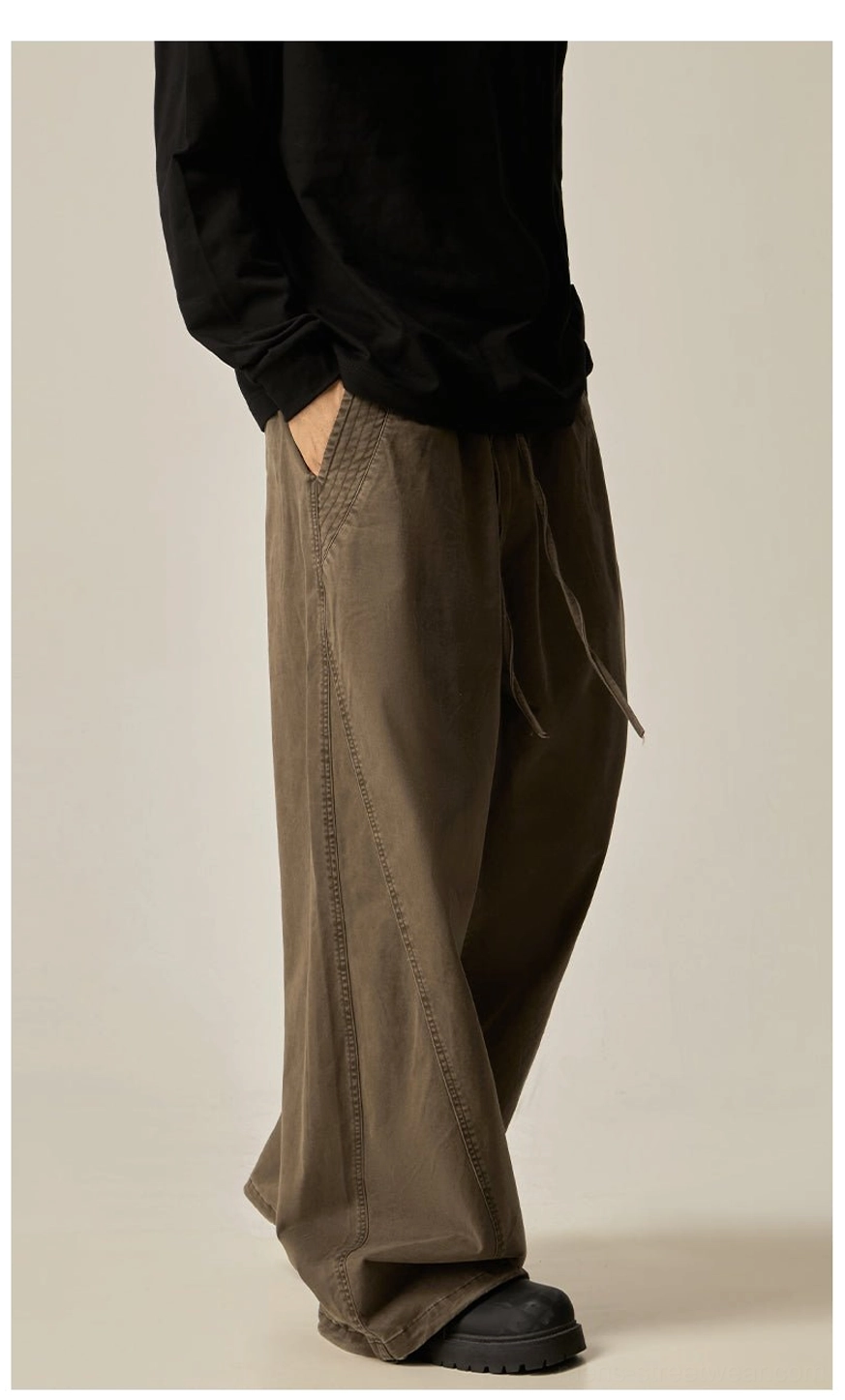 Brown drawstring wide-leg pants right side profile view side pocket relaxed drape dark brown washed fabric oversized proportions