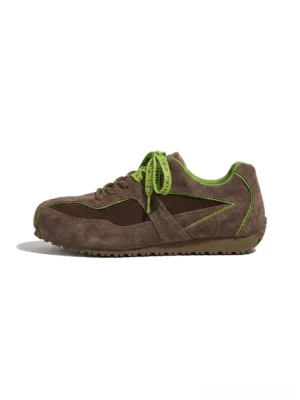 Brown and green contrast suede retro sneakers with green ribbon laces and a low-profile gum-look sole on a white background