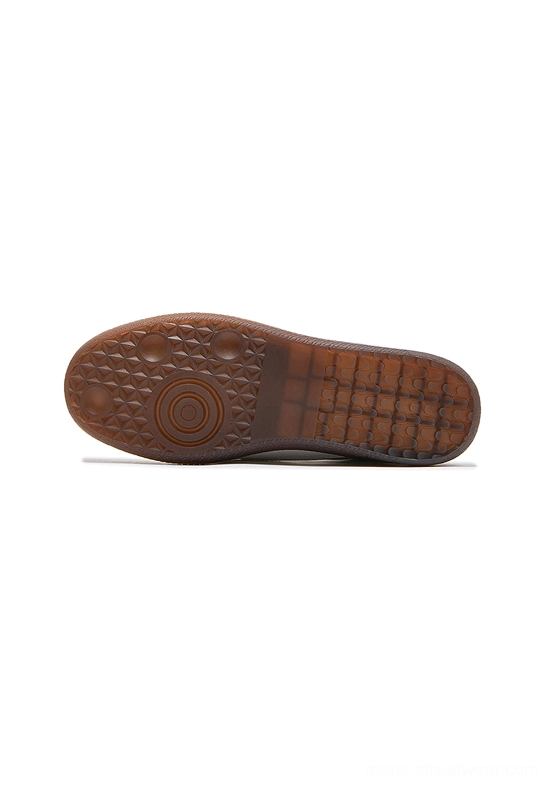 Brown gum rubber outsole of retro sneakers with textured grid tread pattern and circular sole detail