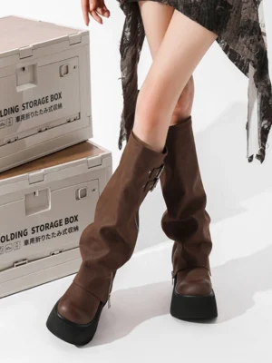 Brown knee-high platform pants-style boots worn with a relaxed grunge streetwear outfit