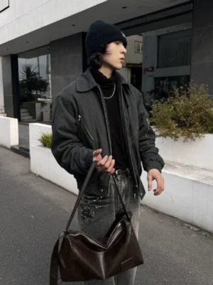 Brown Korean streetwear crossbody shoulder bag with wide strap styled with a dark jacket, black beanie, and denim