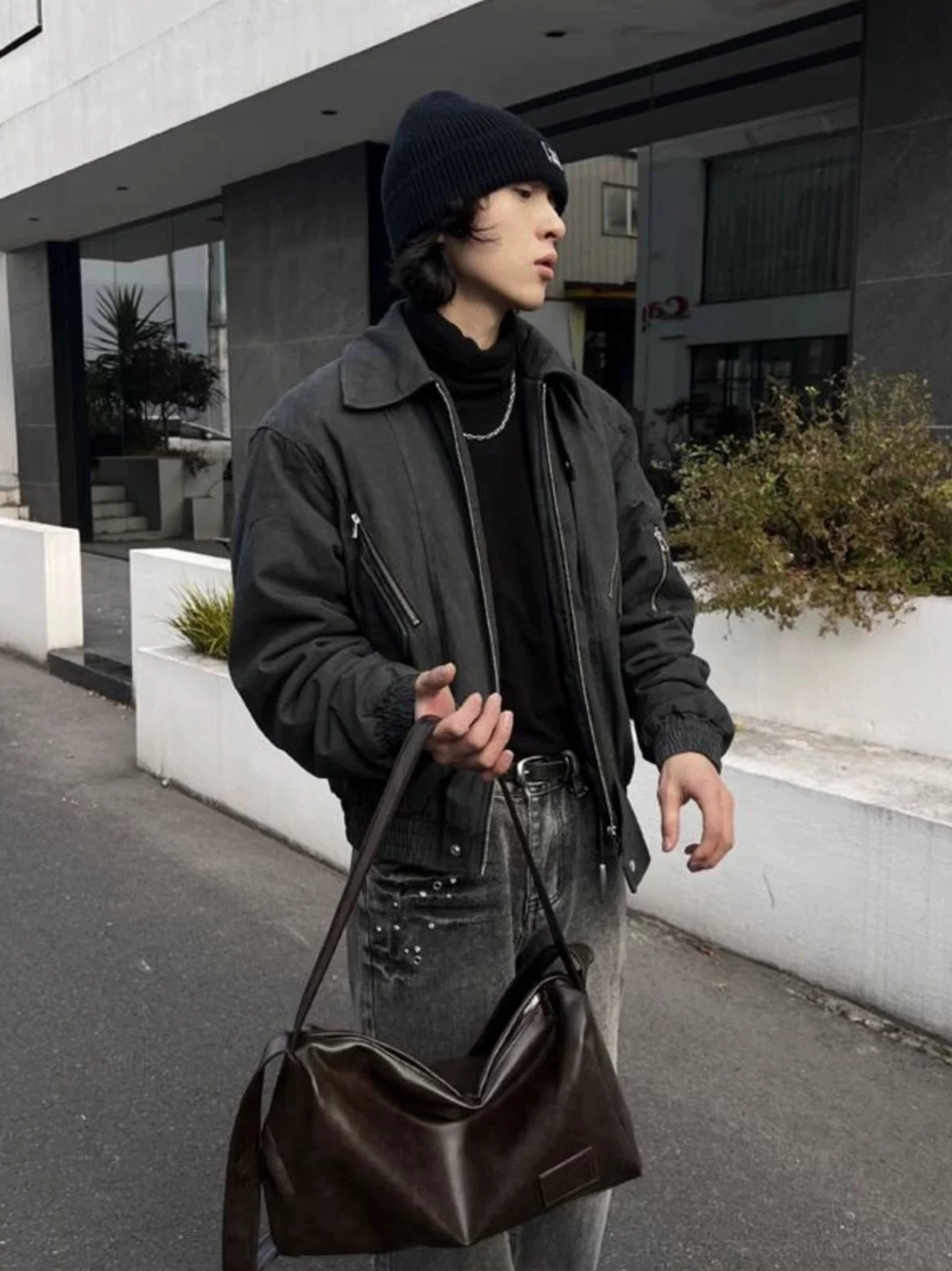 Brown Korean streetwear crossbody shoulder bag with wide strap styled with a dark jacket, black beanie, and denim