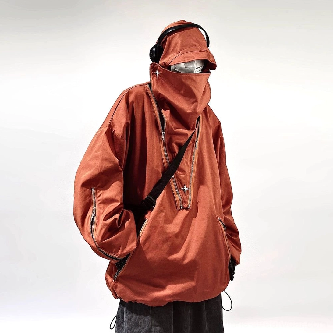 Brown oversized tactical hooded jacket with high neck, crossbody strap styling, sleeve pocket zippers, and urban utility details