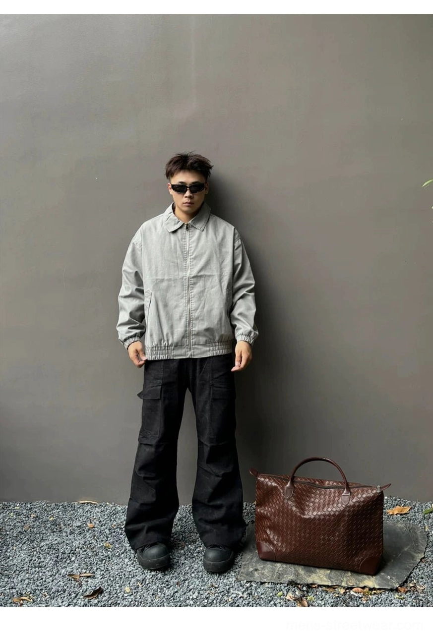 Brown oversized woven PU leather tote bag for men styled with gray streetwear jacket outdoors