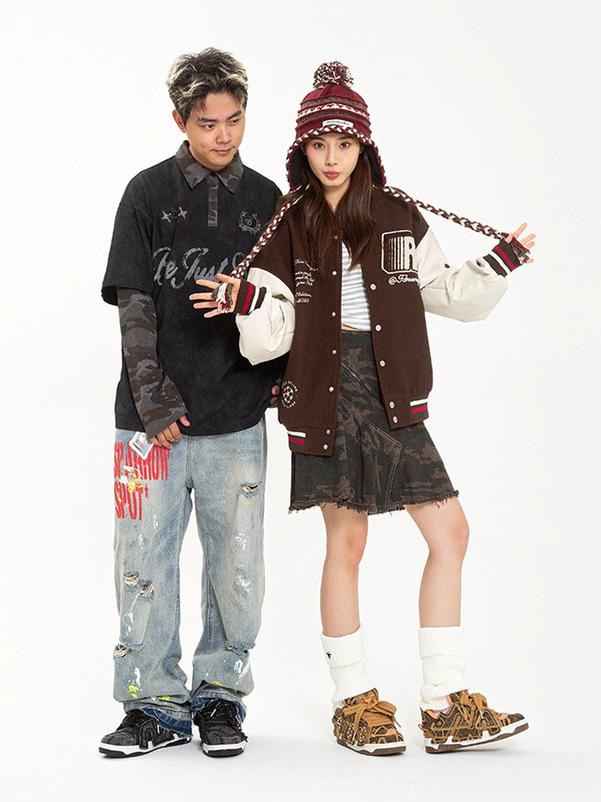 Streetwear couple featuring brown camouflage rivet platform skate sneakers styled with a varsity jacket and casual denim