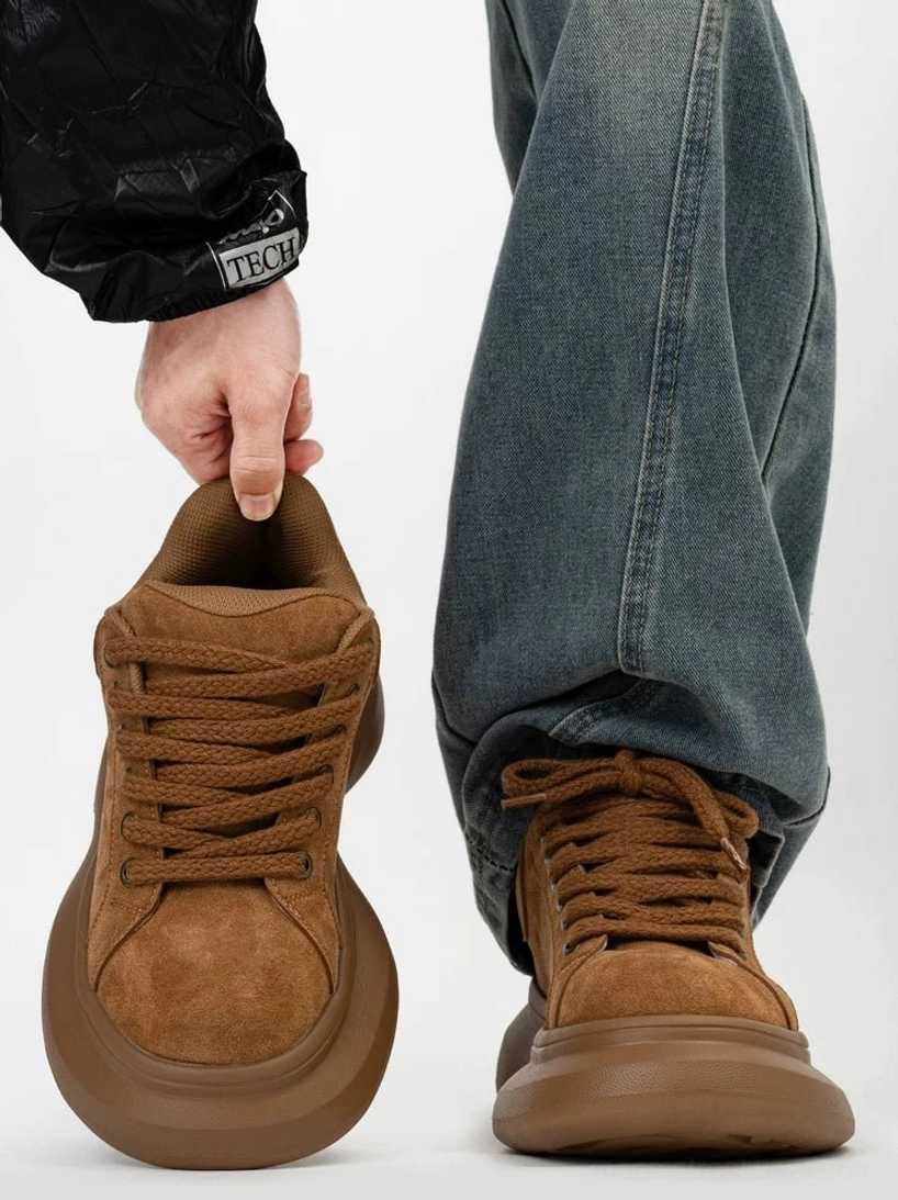 Brown suede platform sneakers shown from a low front angle with chunky wave sole, round toe, lace-up closure, and relaxed Korean streetwear styling
