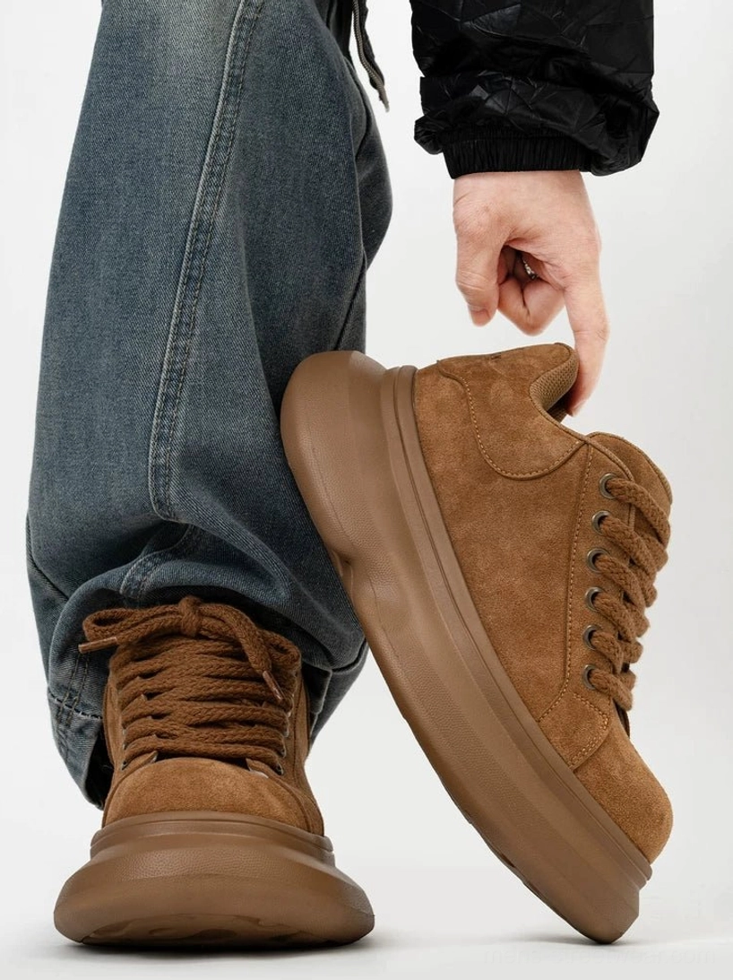 Brown suede thick-soled casual sneakers shown from the side with raised platform outsole, metal eyelets, and textured lace-up design