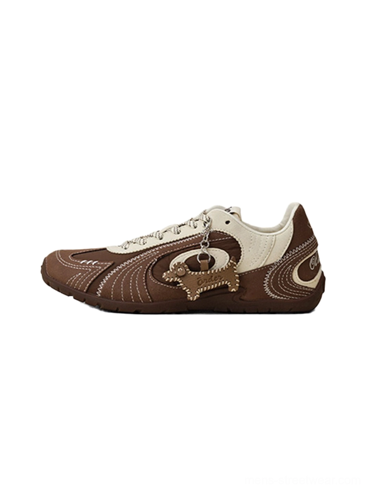 Brown and cream swirl panel retro trainers shown from a side view with stitched overlays and detachable dog pendant