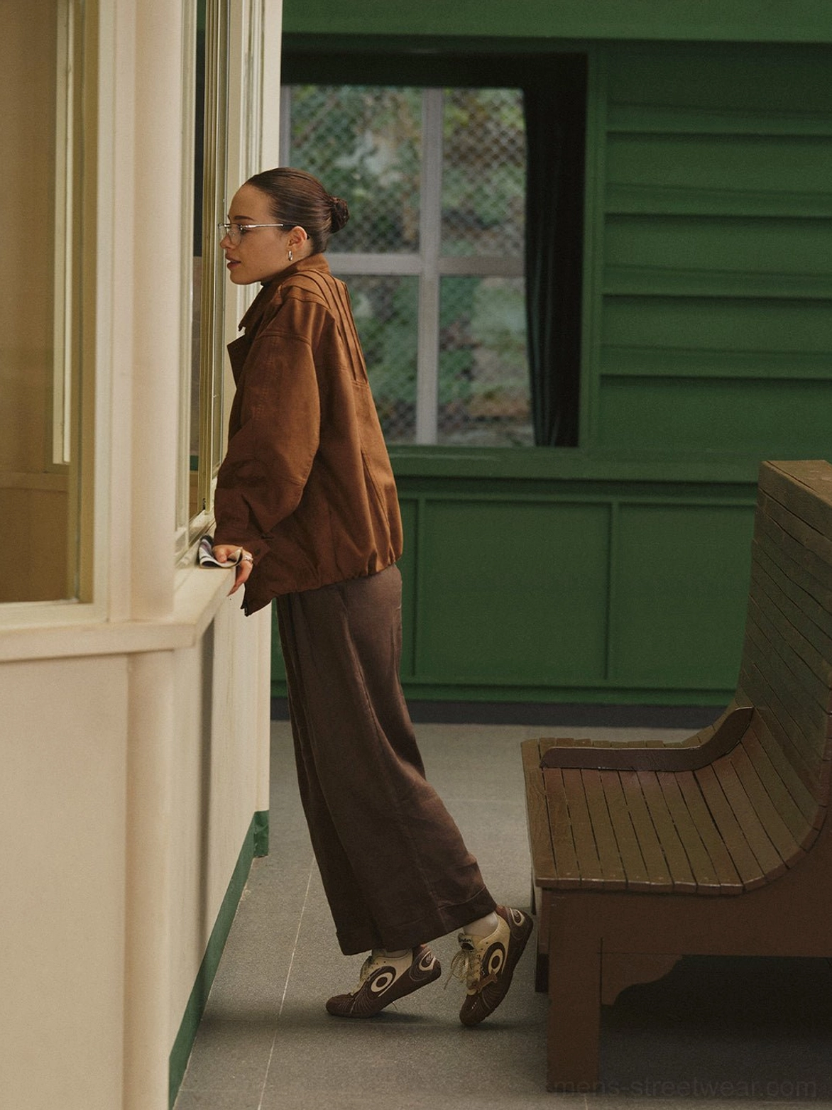 Brown swirl panel retro trainers styled with a tonal corduroy outfit in a vintage street setting
