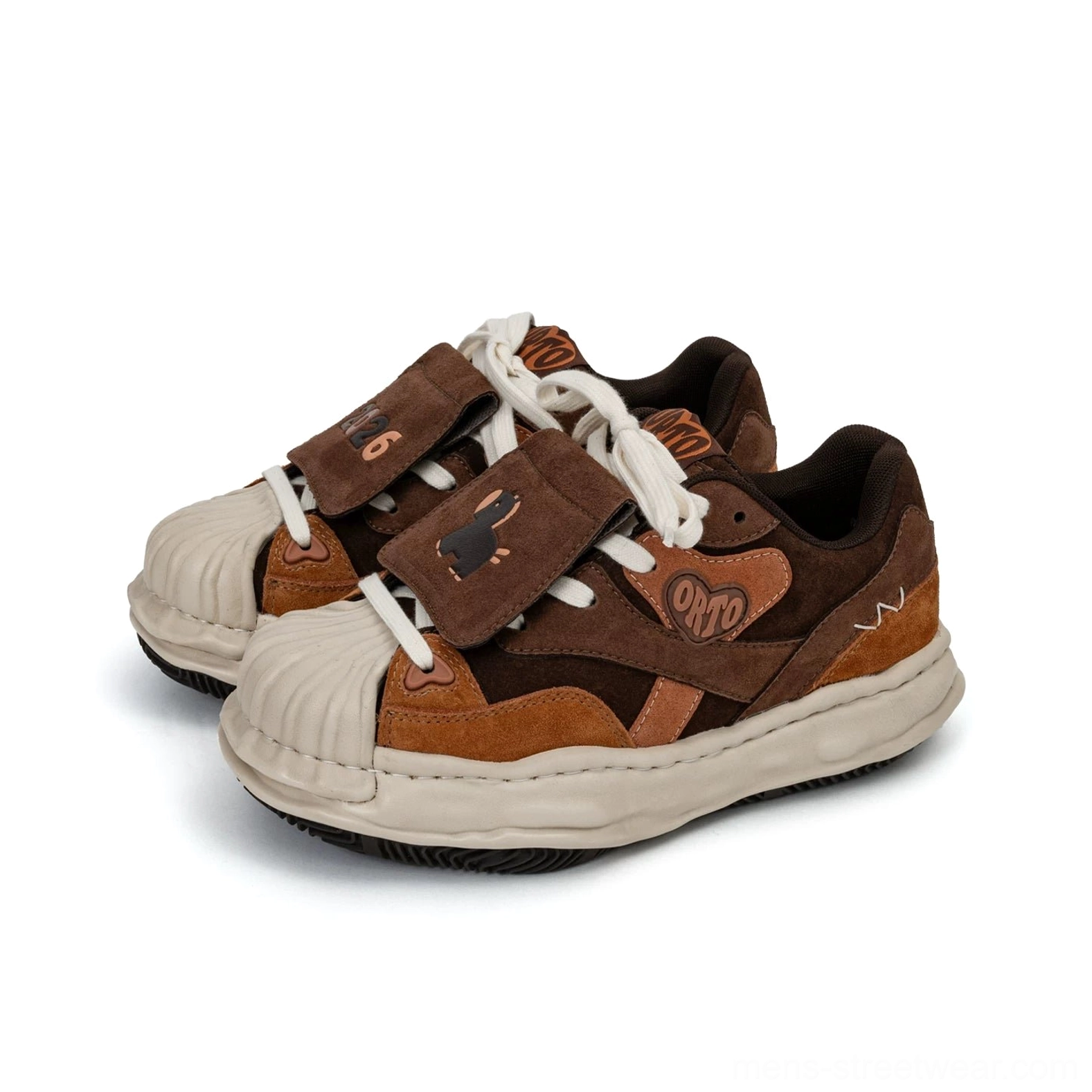 Front three-quarter view of brown and tan patchwork streetwear sneakers with dog embroidery patch white laces and thick cream sole