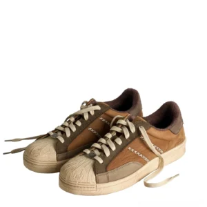 Pair of brown two-tone full-grain leather shell-toe sneakers with cream contrast stitching and retro streetwear outsole