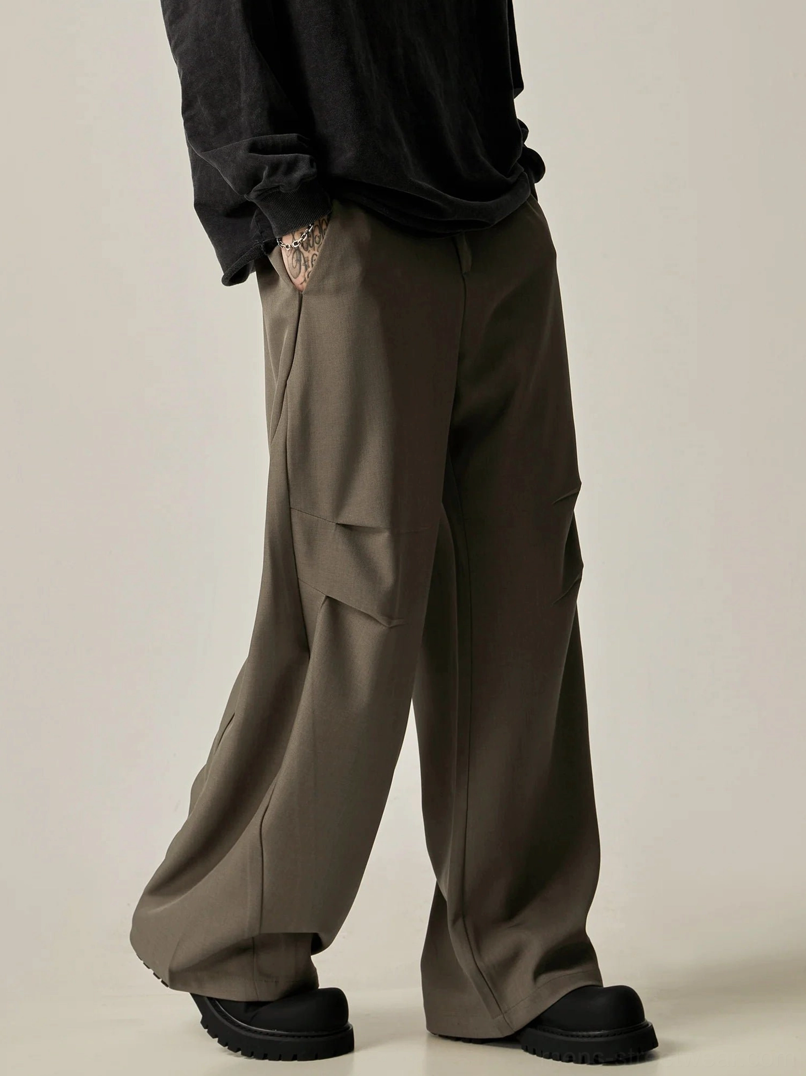 Brown ultra-wide leg tailored trousers side profile showing long flowing wide leg silhouette and clean tailored side seam