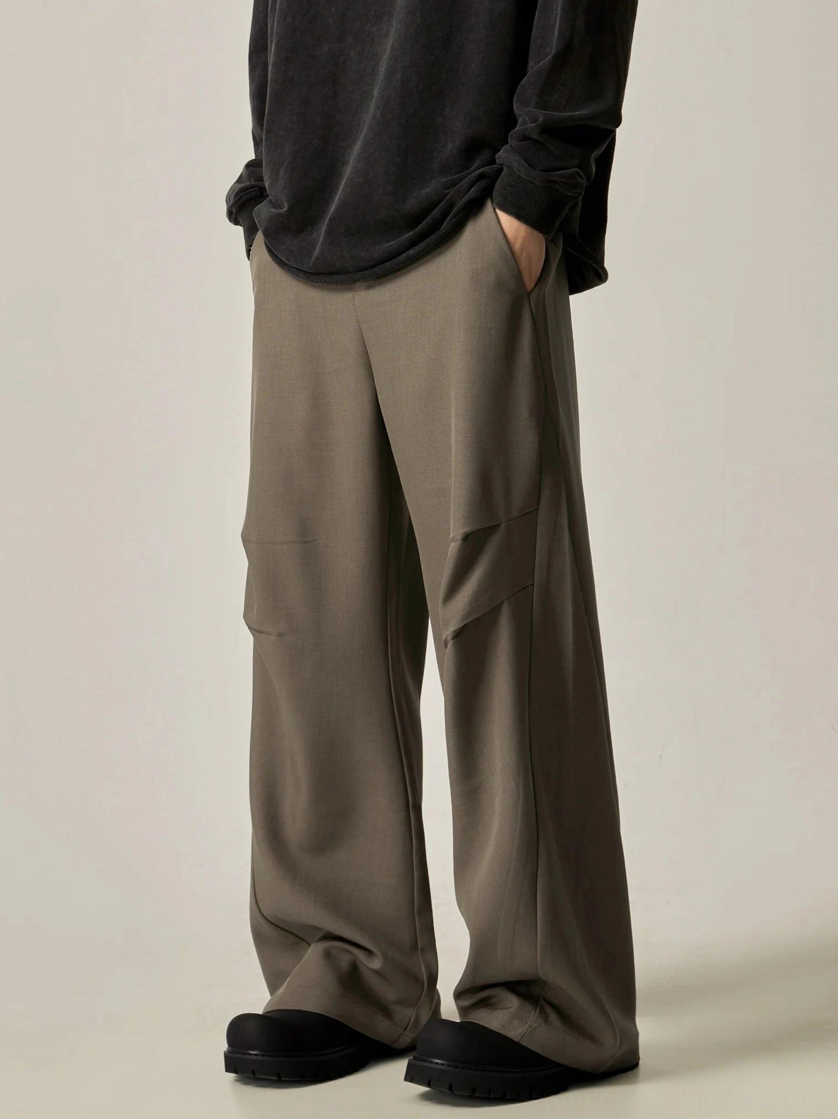 Brown ultra-wide leg tailored trousers side rear view showing side slash pockets structured thigh seams and oversized drape