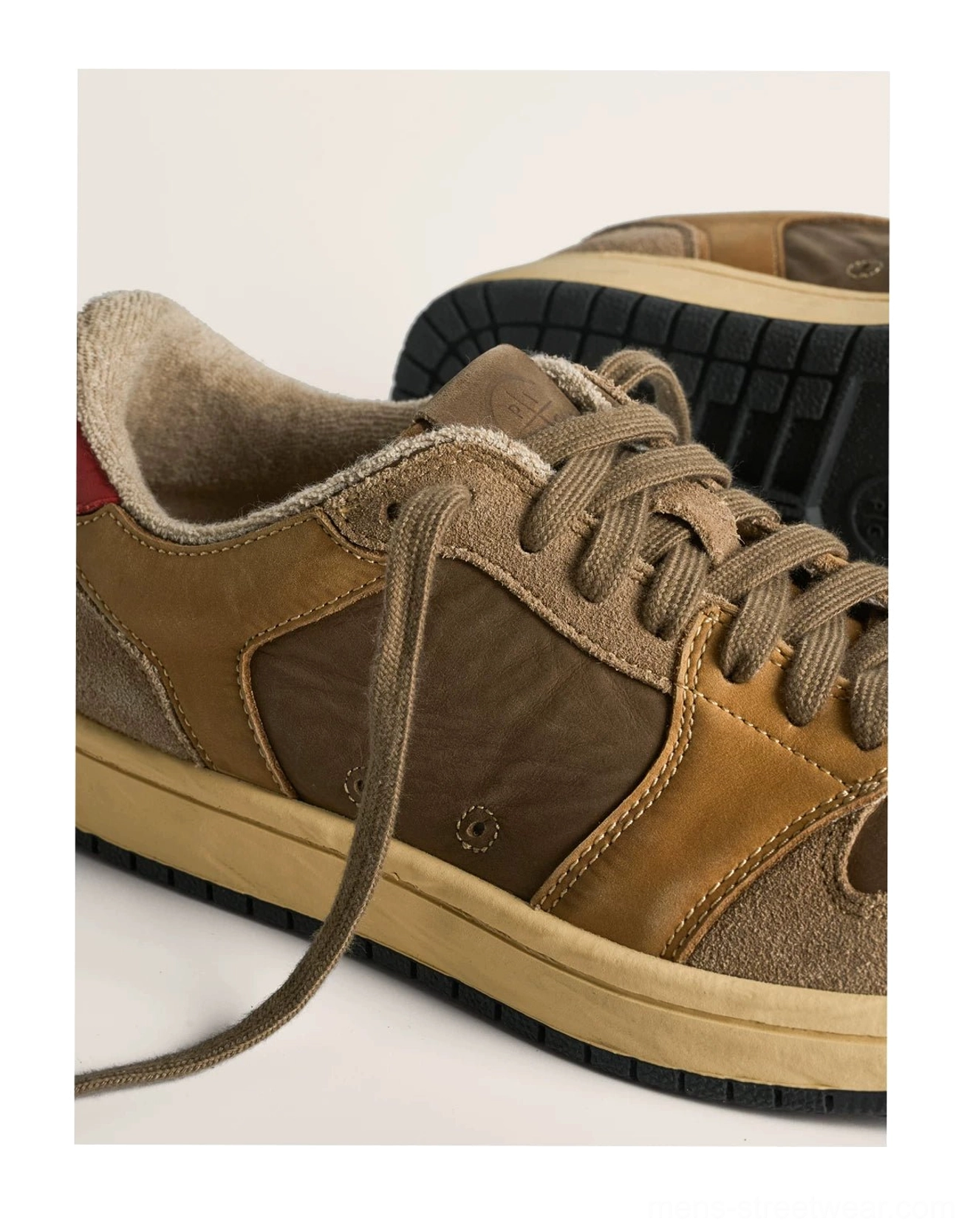 Close-up of brown vintage colorblock leather sneakers showing suede and smooth leather panels soft shearling-style lining red heel tab and rubber outsole tread