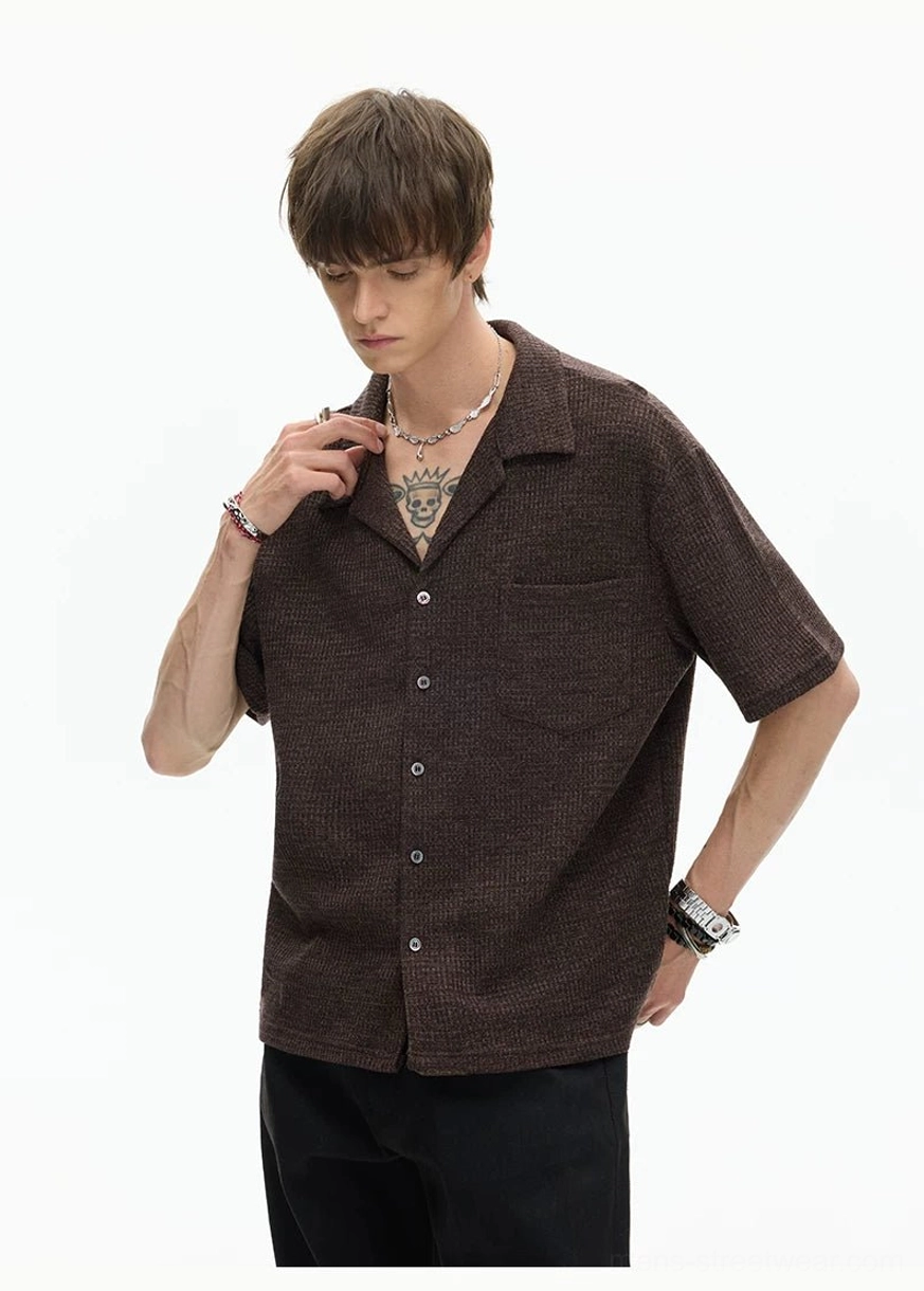 Brown waffle-textured camp collar shirt close-up with short sleeves, front chest pocket, and clean minimalist streetwear design