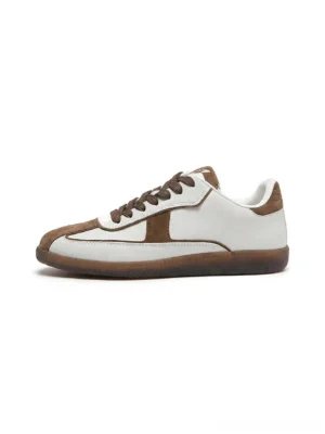 Brown and white suede panel retro gum sole sneakers shown in a clean side profile with brown laces and low profile streetwear silhouette