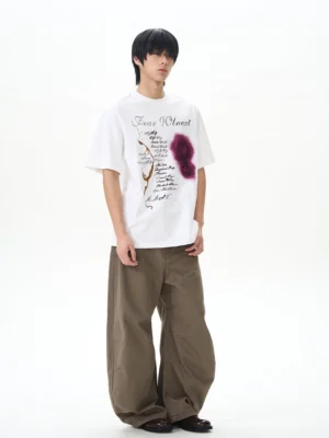 Brown washed denim wide leg pants styled with a graphic white t shirt in a relaxed Korean streetwear outfit