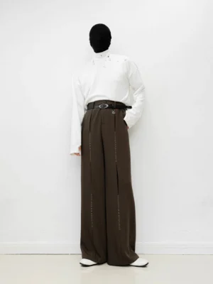 Brown wide-leg tailored trousers shown in a full front view with high waist, front pleats, relaxed drape, and Korean-inspired minimalist styling