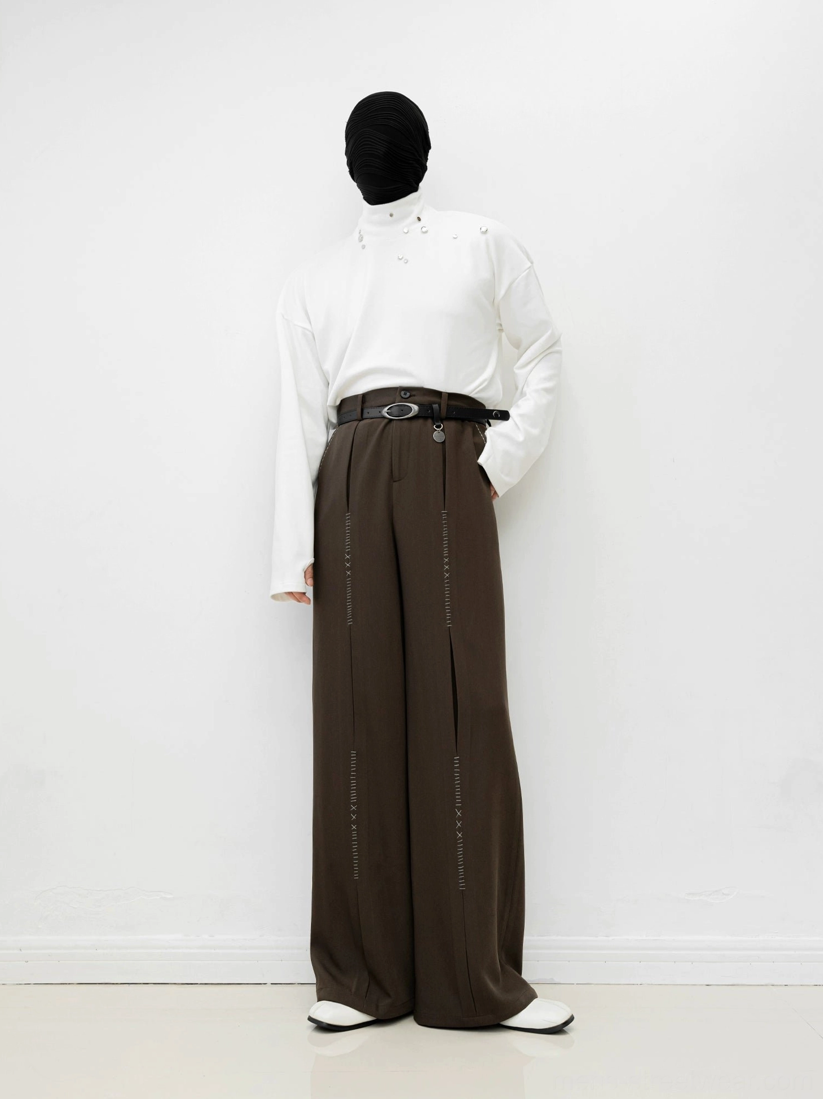 Brown wide-leg tailored trousers shown in a full front view with high waist, front pleats, relaxed drape, and Korean-inspired minimalist styling