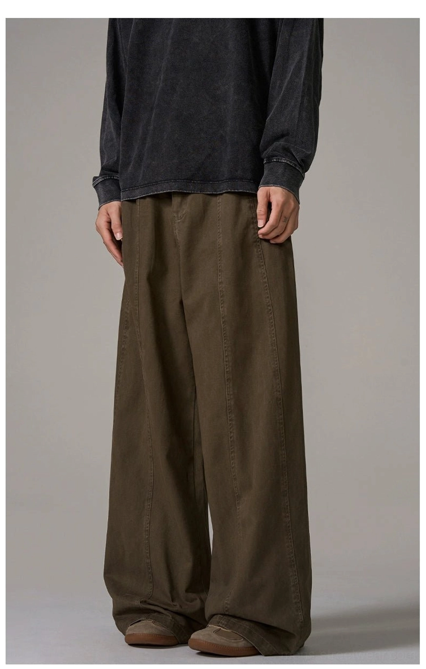 Three-quarter front view of male model wearing brown wide-leg trousers with side pockets and Korean streetwear proportions