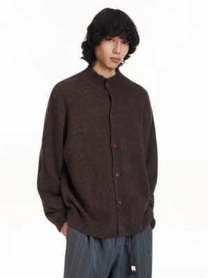 Brown brushed stand collar knit cardigan with red buttons worn with striped wide-leg trousers front view