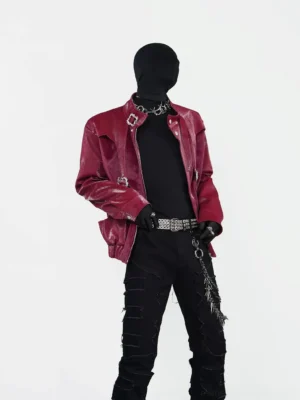 Front view of a burgundy crocodile embossed PU faux leather punk jacket with silver buckle harness straps, stand collar, black streetwear styling and relaxed cropped silhouette