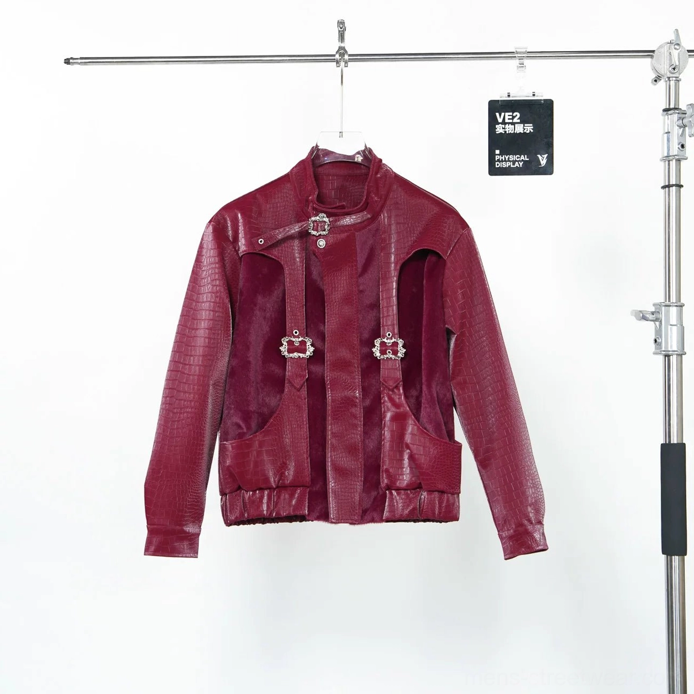Hanging burgundy crocodile embossed punk jacket displaying front buckle straps, stand collar, side patch pockets and glossy PU faux leather texture