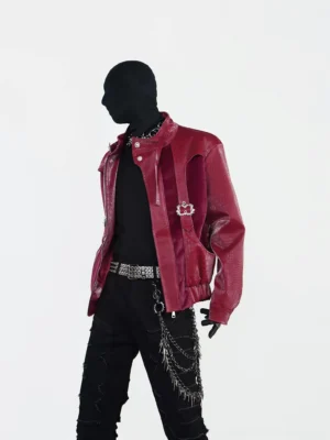 Side view of burgundy crocodile textured punk jacket showing silver square buckles, decorative leather straps, stand collar and short loose streetwear fit