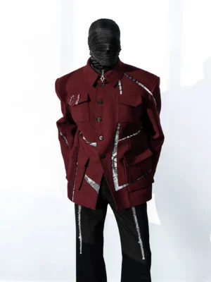 Front full-body view of oversized burgundy deconstructed field jacket with silver metallic trims, cargo flap pockets, and structured shoulders