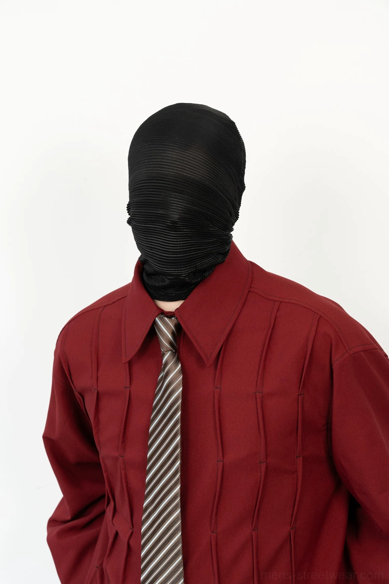 Close up detail of burgundy pleated shirt collar geometric front texture and coordinated taupe gray striped tie