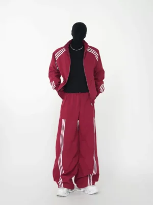 Burgundy triple-stripe track jacket and wide-leg pants set front full-body view with white sneakers