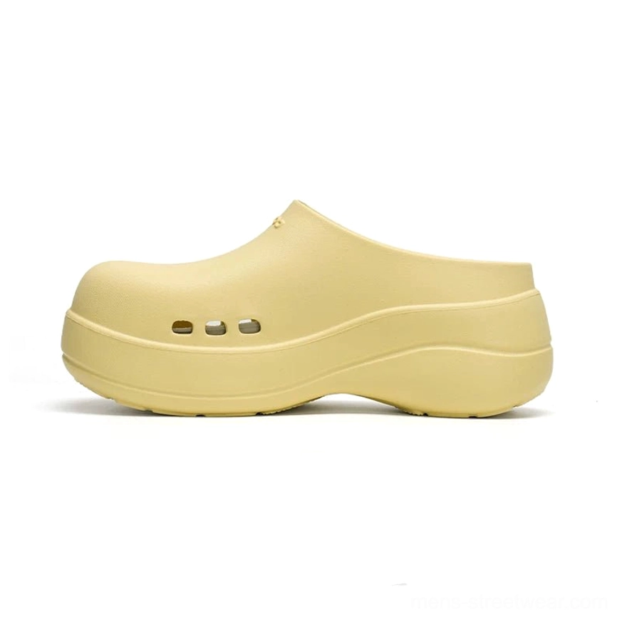 Butter yellow Midnight Wave platform clogs with matte finish, rounded closed toe, three ventilation holes and chunky springy platform sole