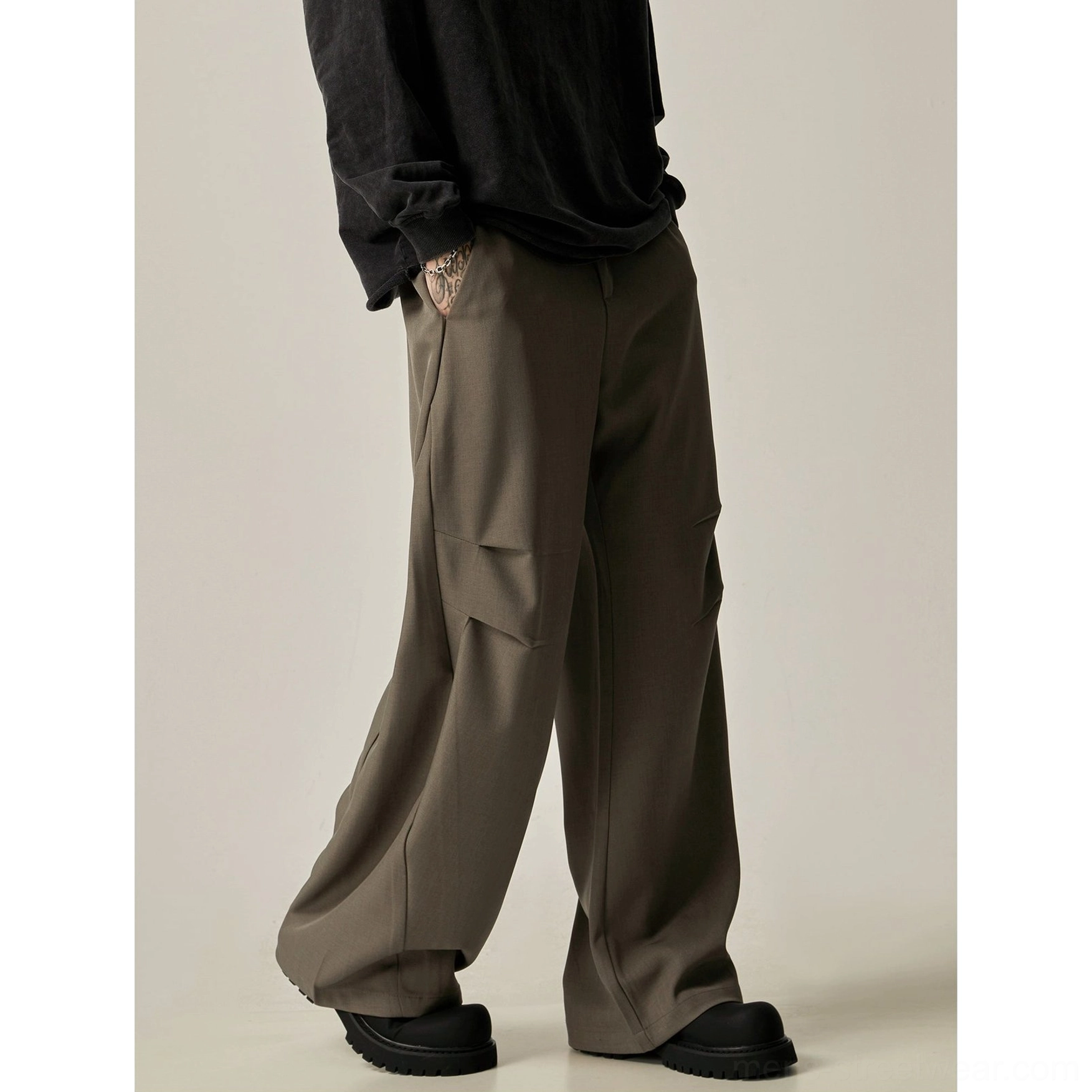 Camel taupe gray wide-leg cargo trousers shown from the rear side with loose draped silhouette, utility pockets, and visible back pocket