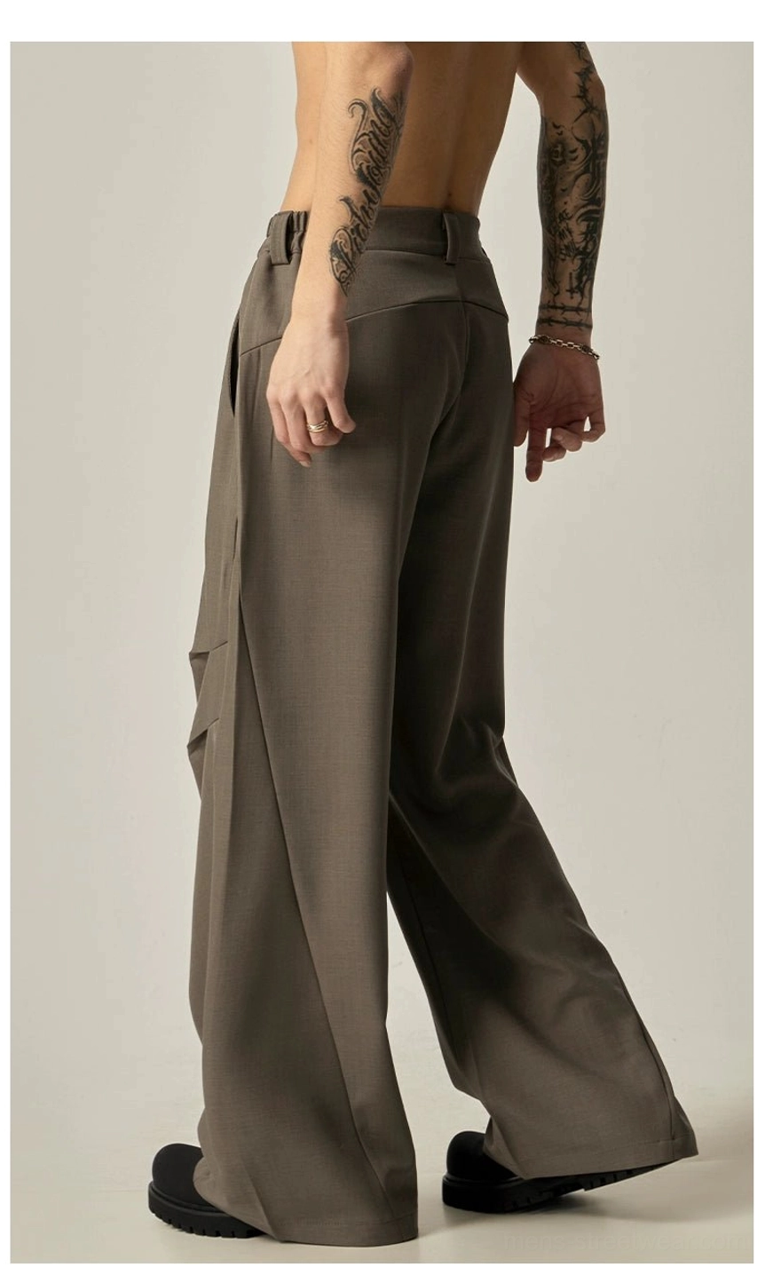 Camel taupe wide-leg streetwear trousers shown from the rear side with exposed waistband, cargo pockets, and flared wide hem