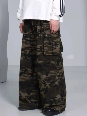 Camouflage wide leg cargo pants styled with a striped cuff top and black leather shoes showing the relaxed fit and front flap pockets