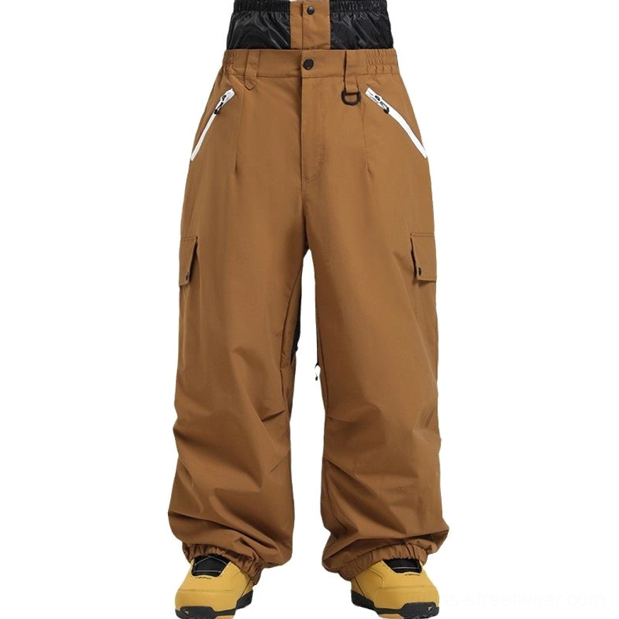 Caramel brown cargo snow pants displayed in a full front view with high waist, pleated waistband, contrast zipper pockets, multiple cargo pockets, and wide-leg fit