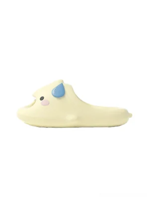 Yellow cartoon shark platform slide slipper with blue fin pink cheek and playful faux fangs on a white studio background