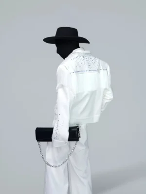 Rear three-quarter view of off-white cropped Western blazer jacket with shoulder fringe and starburst rhinestone embellishment across the back yoke