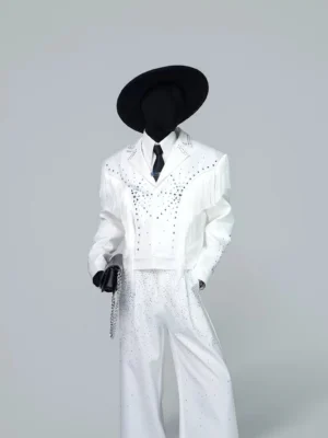 Off-white celestial rhinestone fringe cropped Western blazer jacket styled with black cowboy hat, tie, gloves, and wide-leg trousers in front three-quarter view