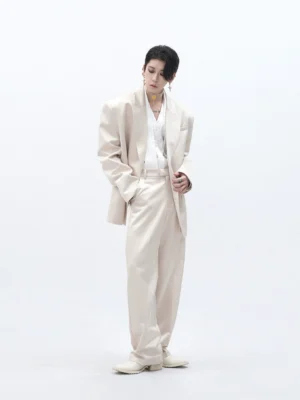 Front view of champagne cream oversized double-breasted blazer and coordinated wide-leg tailored trousers on male model