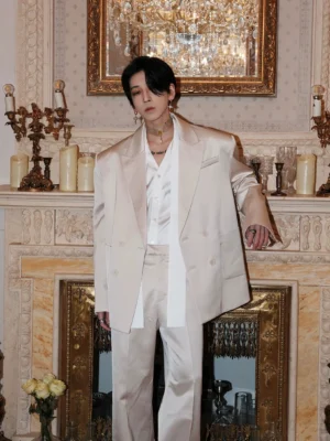 Male model wearing champagne cream oversized double-breasted streetwear blazer with matching wide-leg trousers in a vintage interior