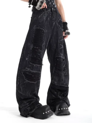 Charcoal ash distressed wide-leg balloon jeans three-quarter side view showing frayed denim panels and oversized streetwear silhouette