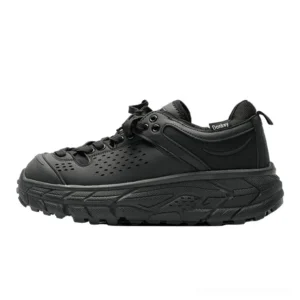 Charcoal black chunky trail sneakers with breathable perforated upper, heel tag, rugged platform sole, and deep traction outsole shown from the left side