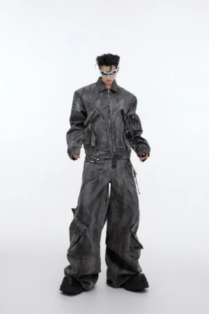 Full-body front view of model wearing charcoal distressed denim cargo jeans with oversized utility pockets and adjustable buckle straps in a Korean streetwear outfit
