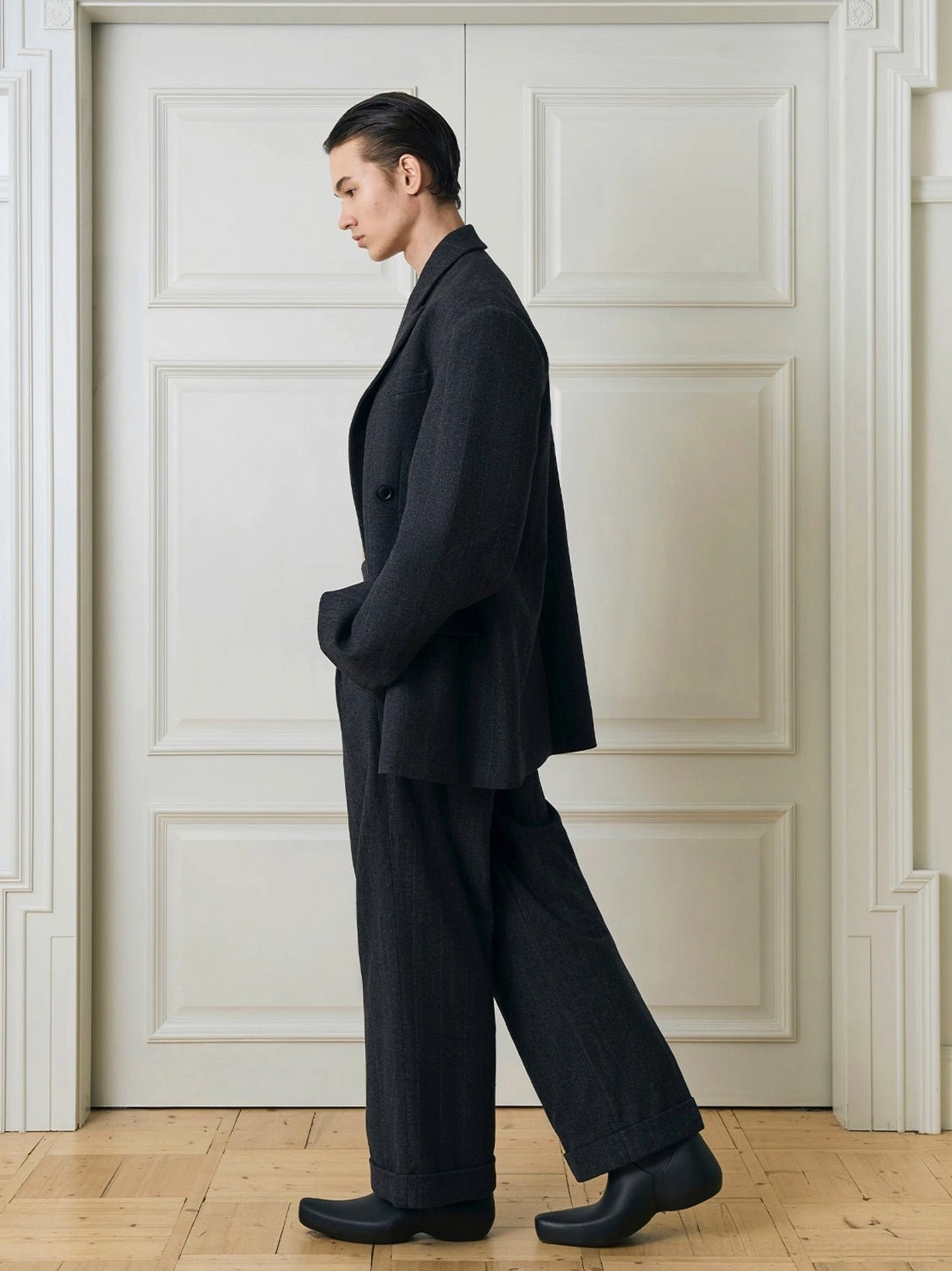 Fastened charcoal double-breasted oversized suit blazer with cuffed wide-leg trousers right side view
