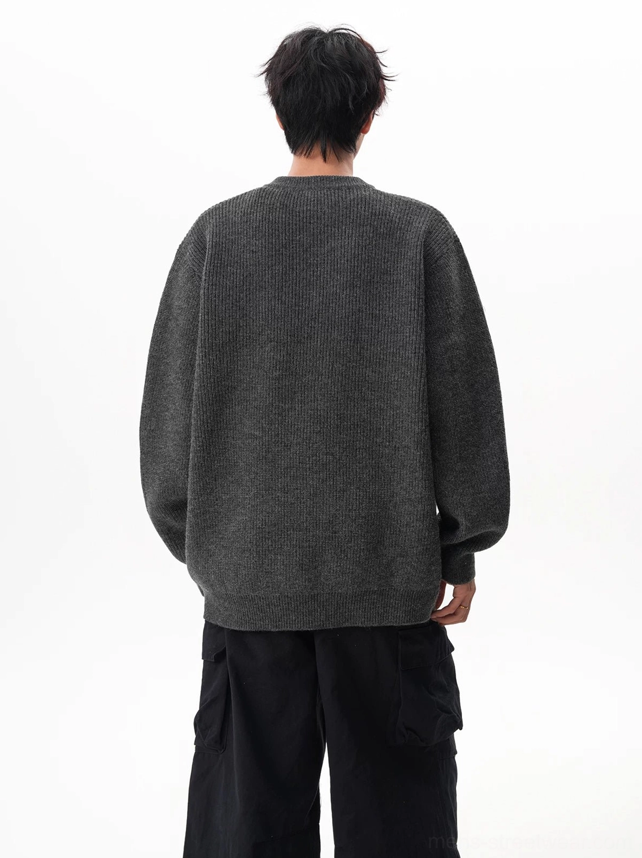 Back view of a charcoal gray oversized waffle Henley sweater with a clean knit surface and dropped shoulder construction
